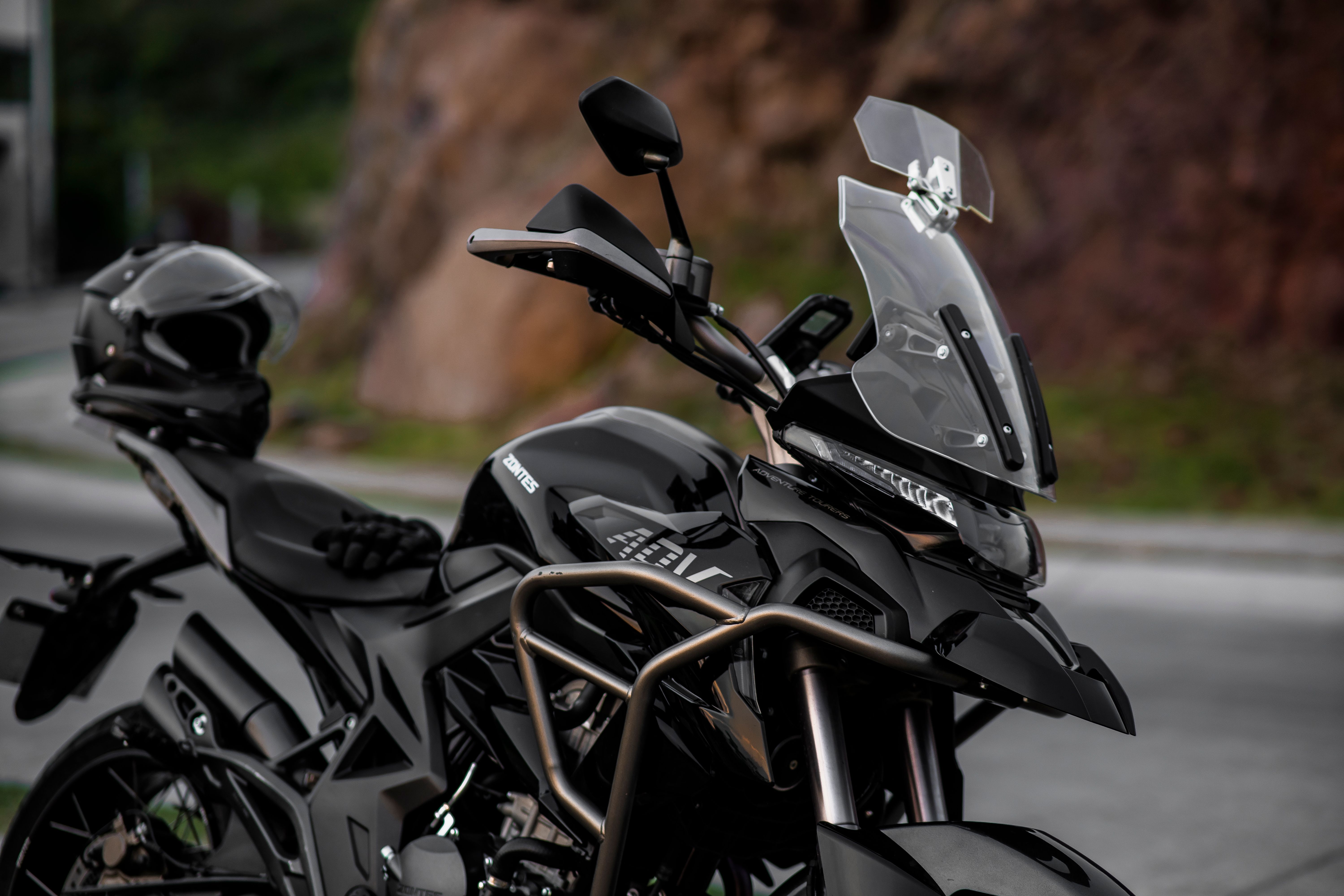 Parked black adventure motorcycle with a tall windshield for wind protection