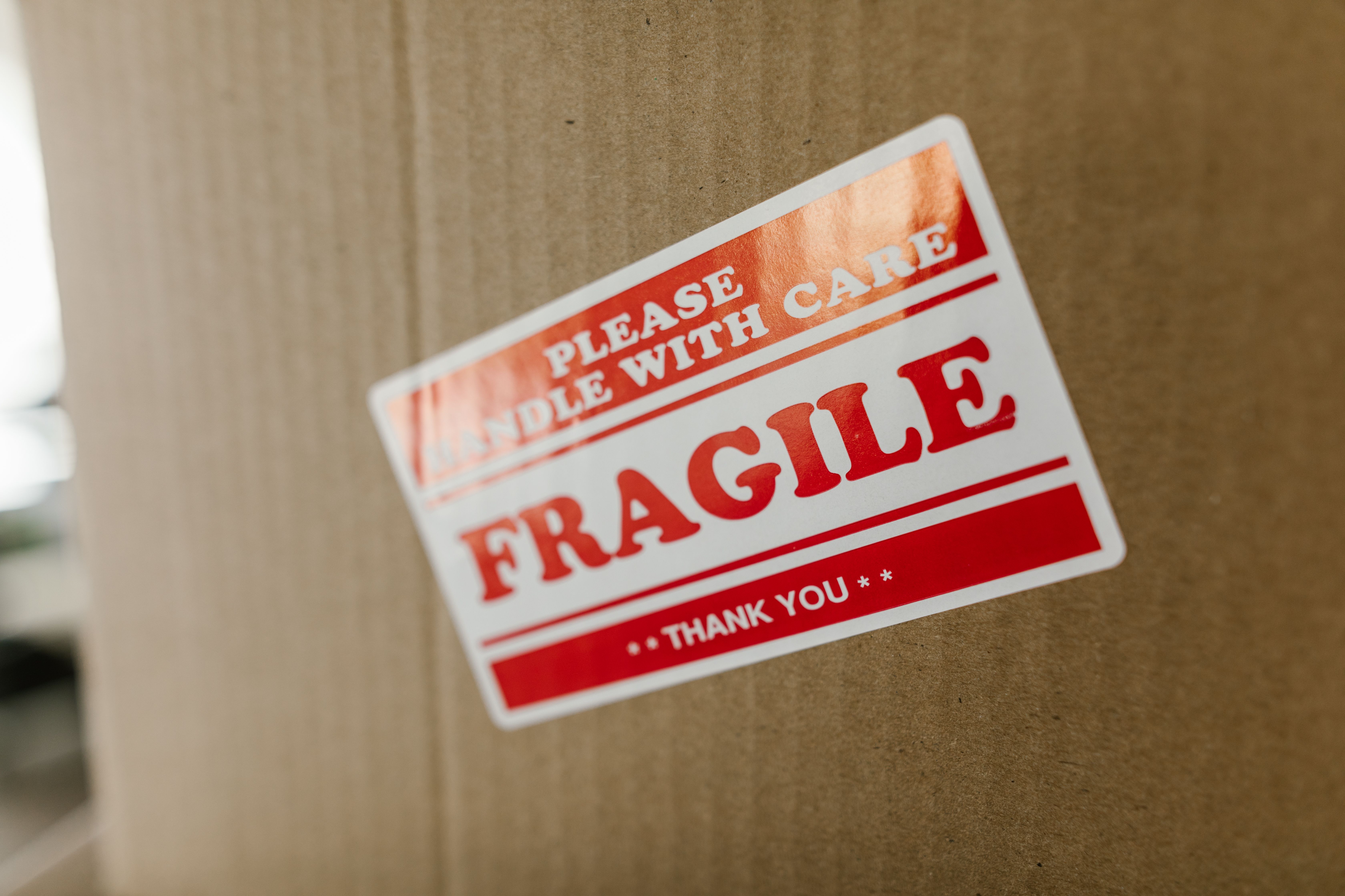 Cardboard box labeled with a fragile handle with care sticker for safe shipping