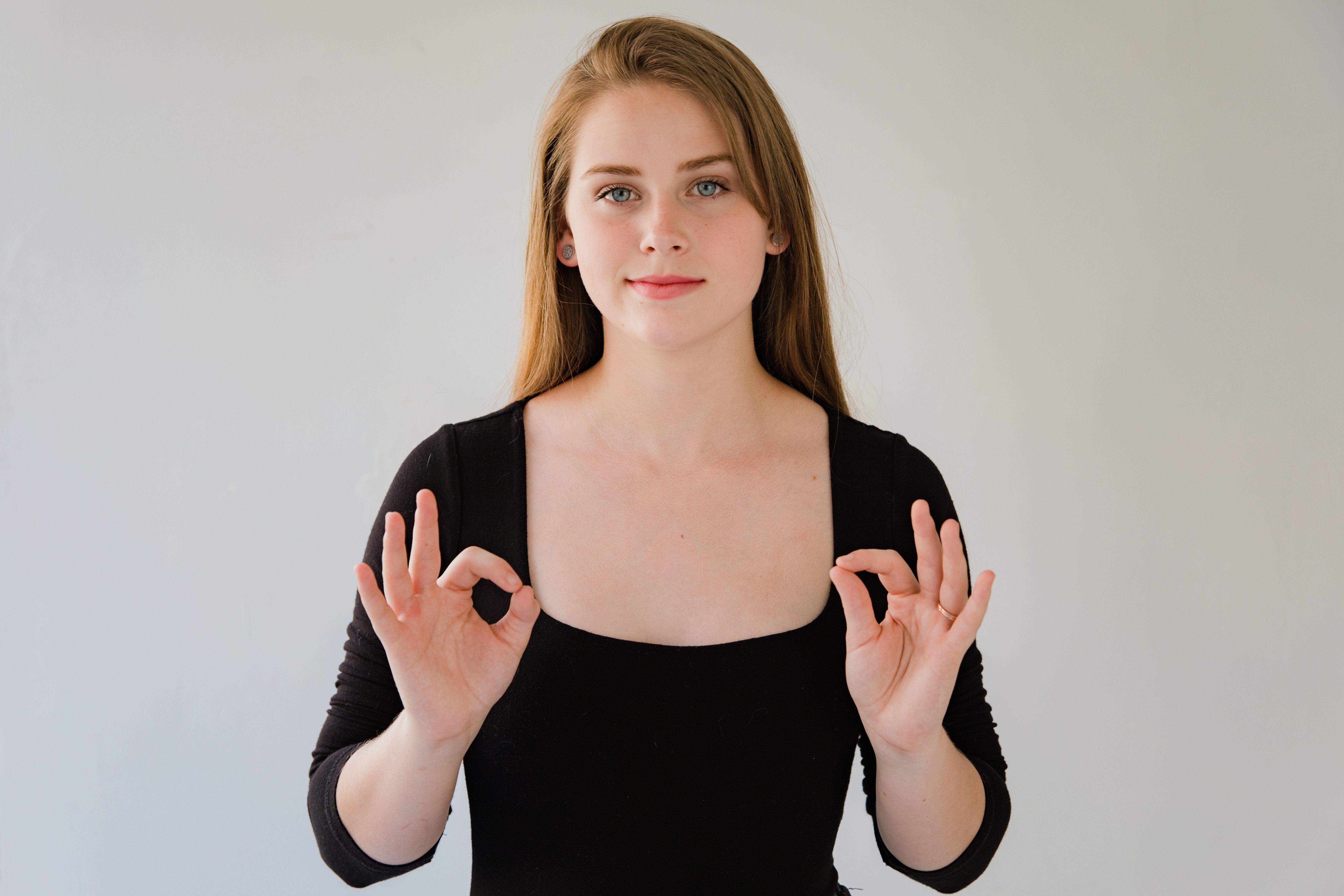 Woman using expressive hand gestures to communicate, illustrating the role of body language.