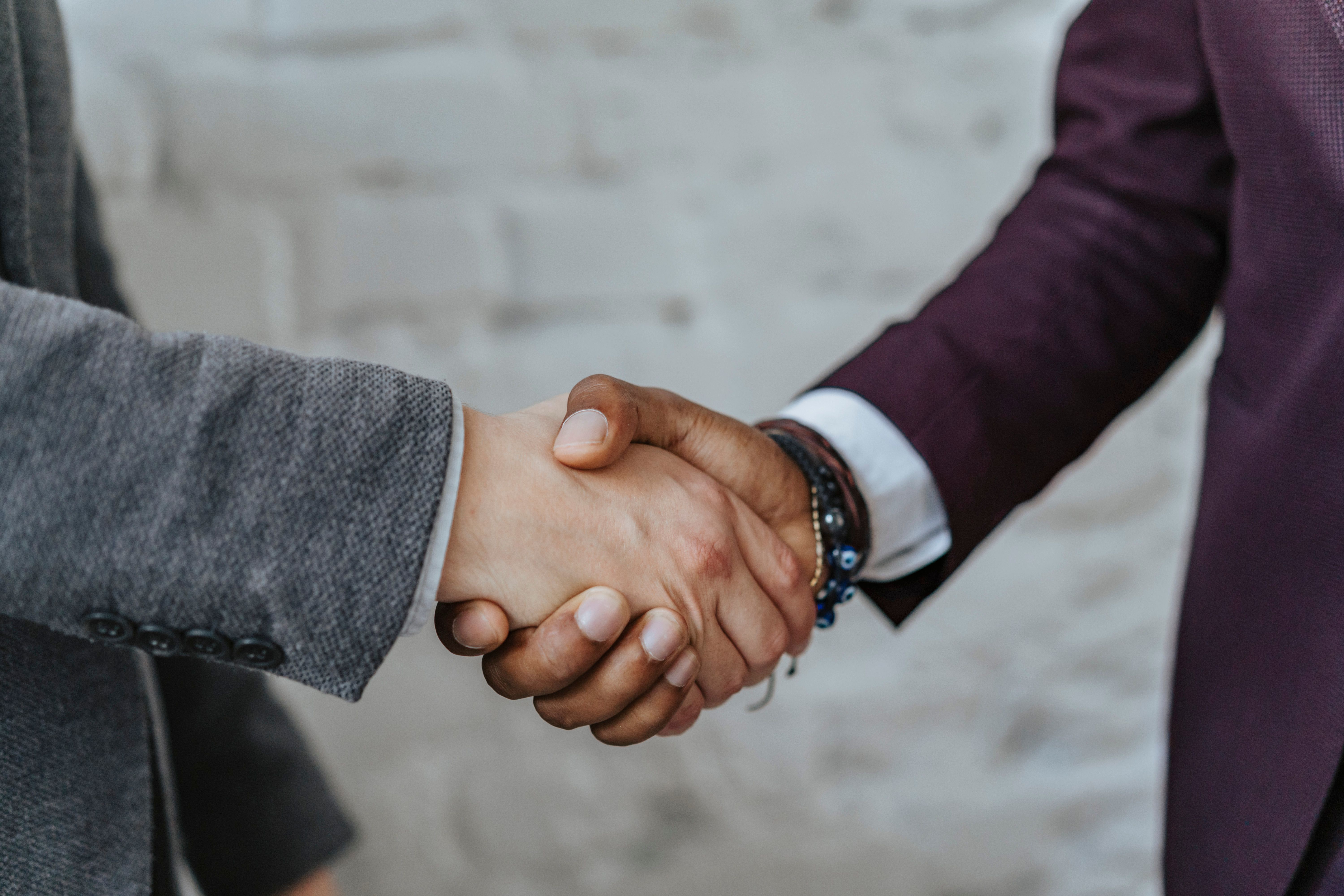 Two people shaking hands during a professional introduction, illustrating trust and connection.