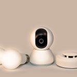 Modern smart home gadgets including a smoke detector and security camera